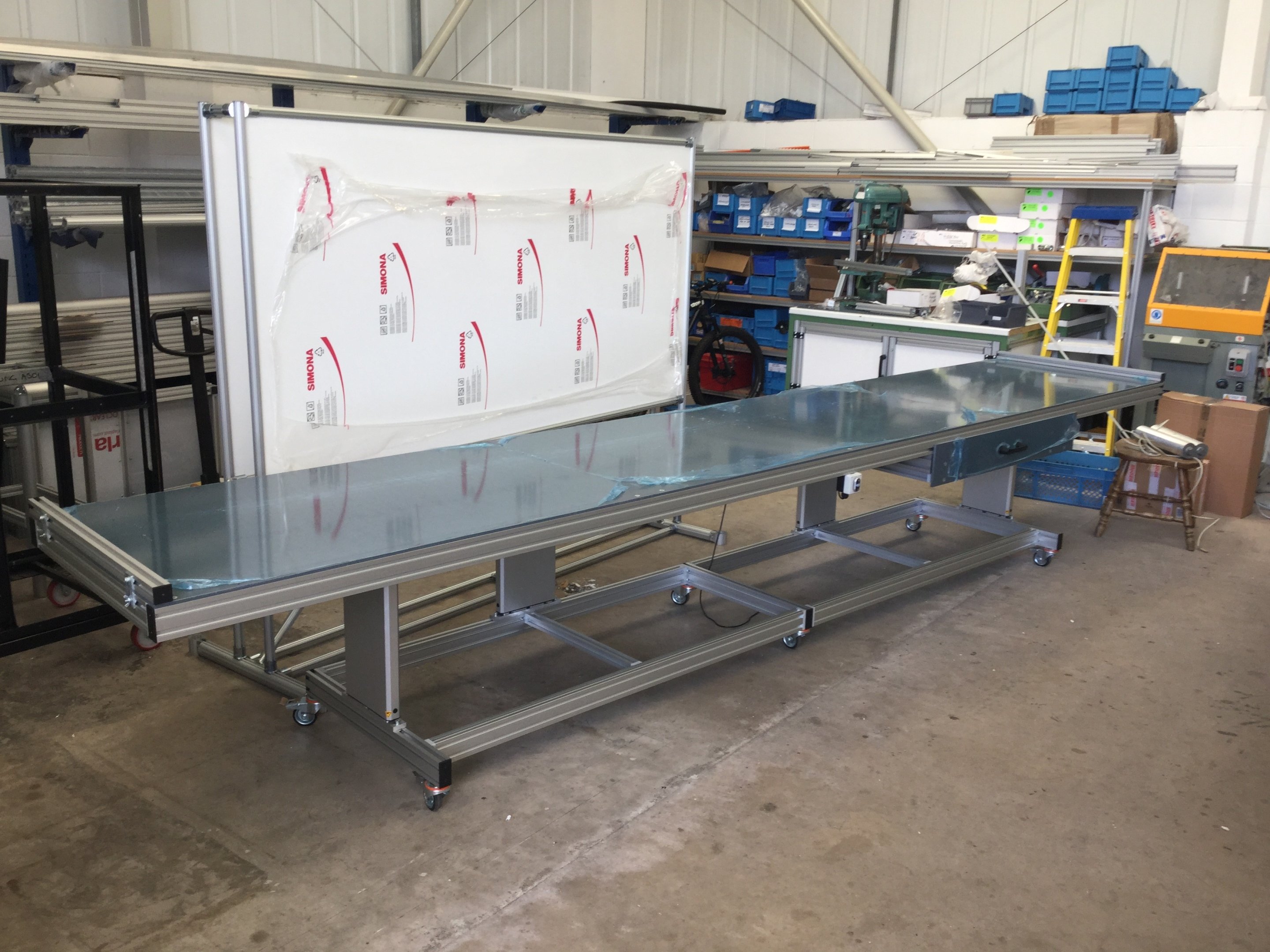 Height+adjustable+table+with+integrated+drawer An Image of a custom table and magnetic board we created